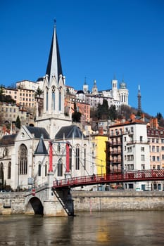 Lyon city with church and footbridge in blue sky