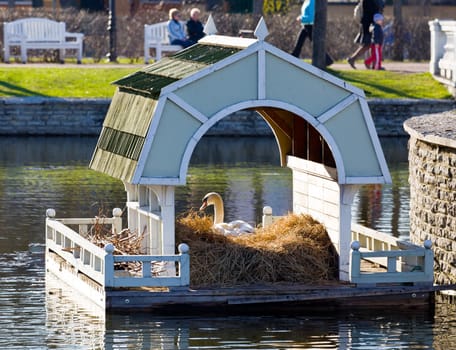 Ornate Swan house and nest in the ornamental pond in Kadriorg gardens by the palace in Tallinn Estonia