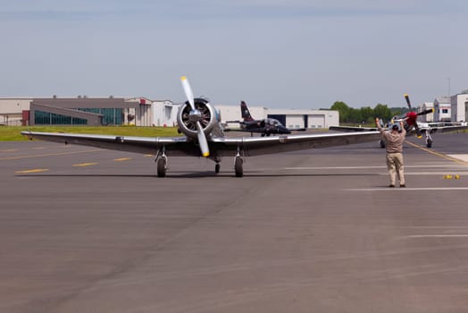 AT-6 Texan, known as the Harvard training plane leads Mustang and Albatros to runway