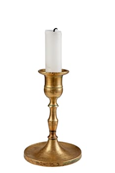 Antique brass candle holder with white pillar candle. Isolated over white.