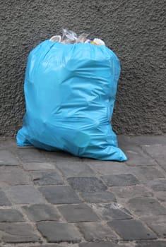 One blue garbage pack in the street