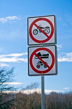 No motorcycles, no snowmobiles, no all-terrain vehicles, road sign.