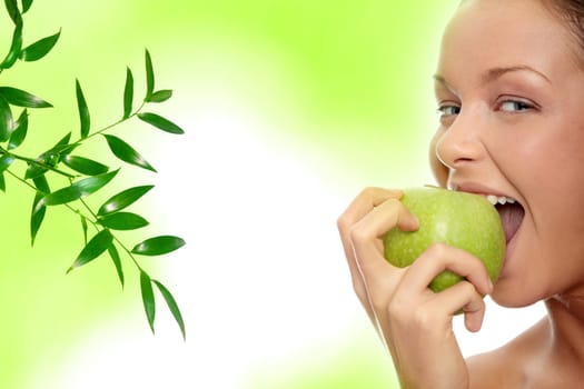 Caucasian beauty with green apple, against abstract green background