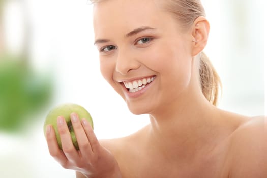 Beautiful girl eating green apple isolated on white background