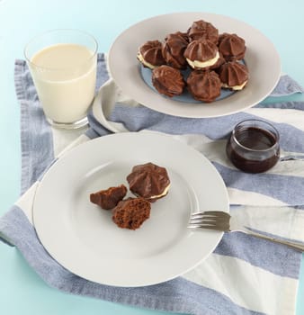 Delicious fresh baked chocolate star biscuits with chocolate sauce and a glass of milk.