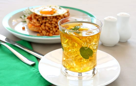 Delightful mint and lemon iced tea with baked beans for breakfast.