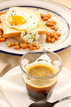 Fried egg with beans with a strong short black coffee.