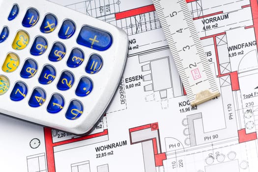 Calculator and ruler on a house plan for calculation