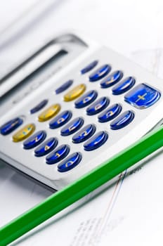 Detail of an industrial plan with green pencil and calculator