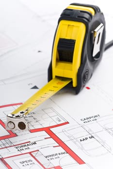 A roll meter on a house plan for measuring