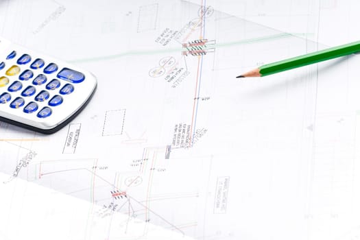 Detail of an industrial plan with green pencil and calculator