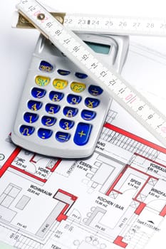 Calculator and ruler on a house plan for calculation