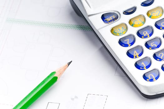 Detail of an industrial plan with green pencil and calculator