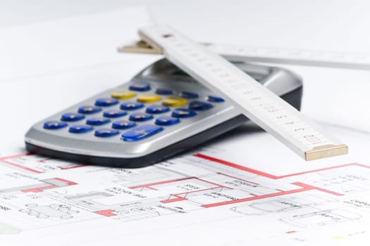 Calculator and ruler on a house plan for calculation