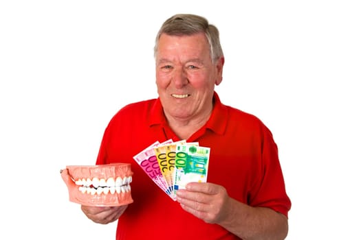 Friendly senior holding model of a set of teeth