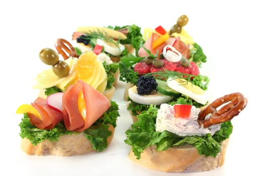 Various canapes against white background