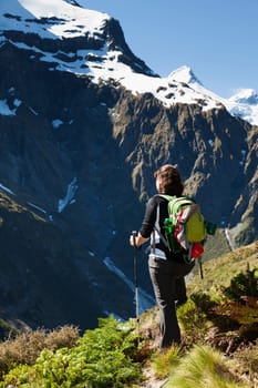 Woman hiker looking out at the mountain tops in New Zealand