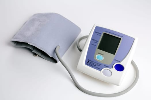 At home digital blood pressure monitor on white background.