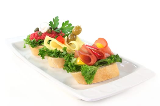 Various canapes against white background