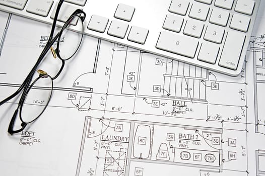 Modern architect&#039 s office with blueprint and computer keyboard