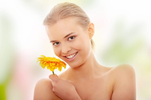Portrait of the attractive girl without a make-up, with flower in hand
