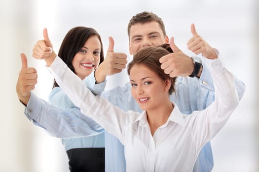 Happy business team with thumbs up