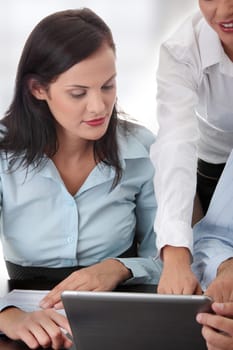 Interracial business team working at laptop in a office