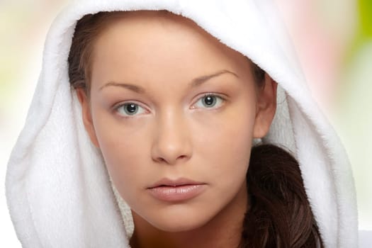 Beautiful young caucasian woman in bathrobe after bath calm portrait.