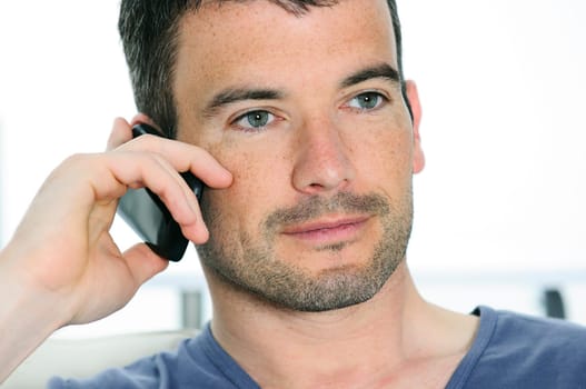 relaxed man with having a communication with a cellephone