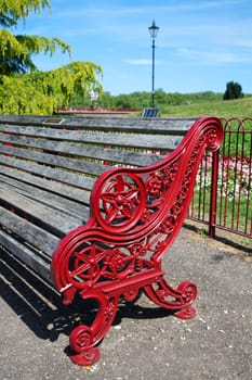 Empty red bench in park