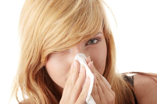 Young blonde woman having a cold close up isolated on white background