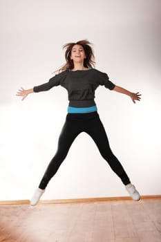 Young stylish woman training modern dance