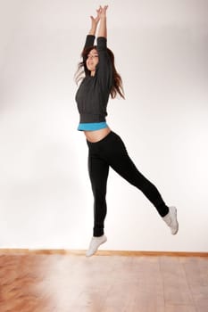 Young stylish woman training modern dance