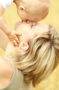 Small baby with mother outdoors. Summer Time.