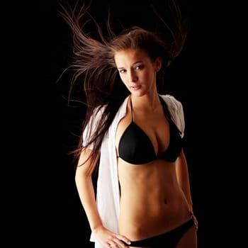 Young beautiful slim woman posing in bikini - with wind - isolated on black