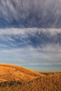autumn hill and a blue sky with clouds