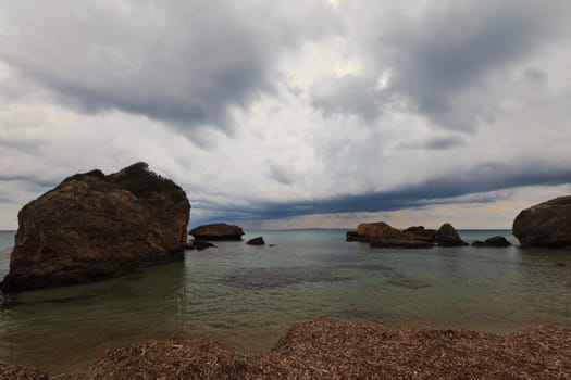 rocks in the sea and sky with clouds, beach Porto Zoro, Zakynthos, Greece