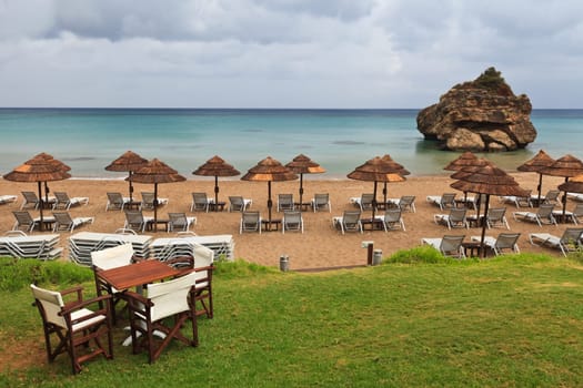 a deserted beach full of sun beds