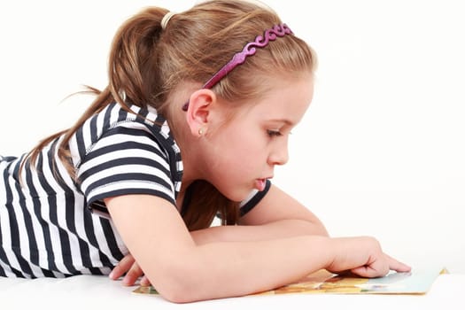 Cute little girl reading a book