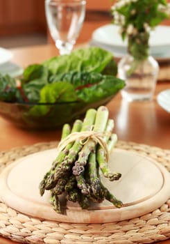 Green asparagus and spinach on the table