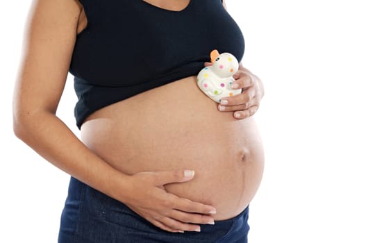 Pregnant woman playing with spotted toy duck