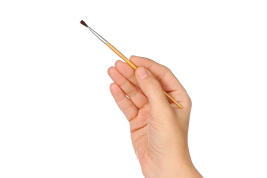hand and brush over a white background