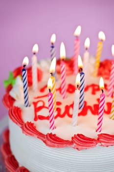 Birthday cake with burning candles and icing