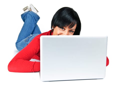 Smiling black woman peeking from behind computer laying on floor