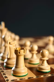Close up of white chess pieces on wooden chessboard
