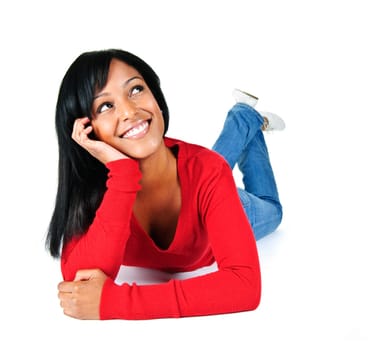 Portrait of black woman looking up smiling and laying on white background