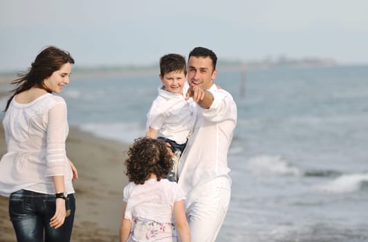 happy young family have fun and live healthy lifestyle on beach