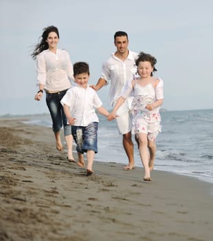 happy young family have fun and live healthy lifestyle on beach