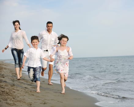 happy young family have fun and live healthy lifestyle on beach