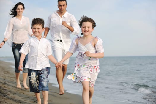 happy young family have fun and live healthy lifestyle on beach